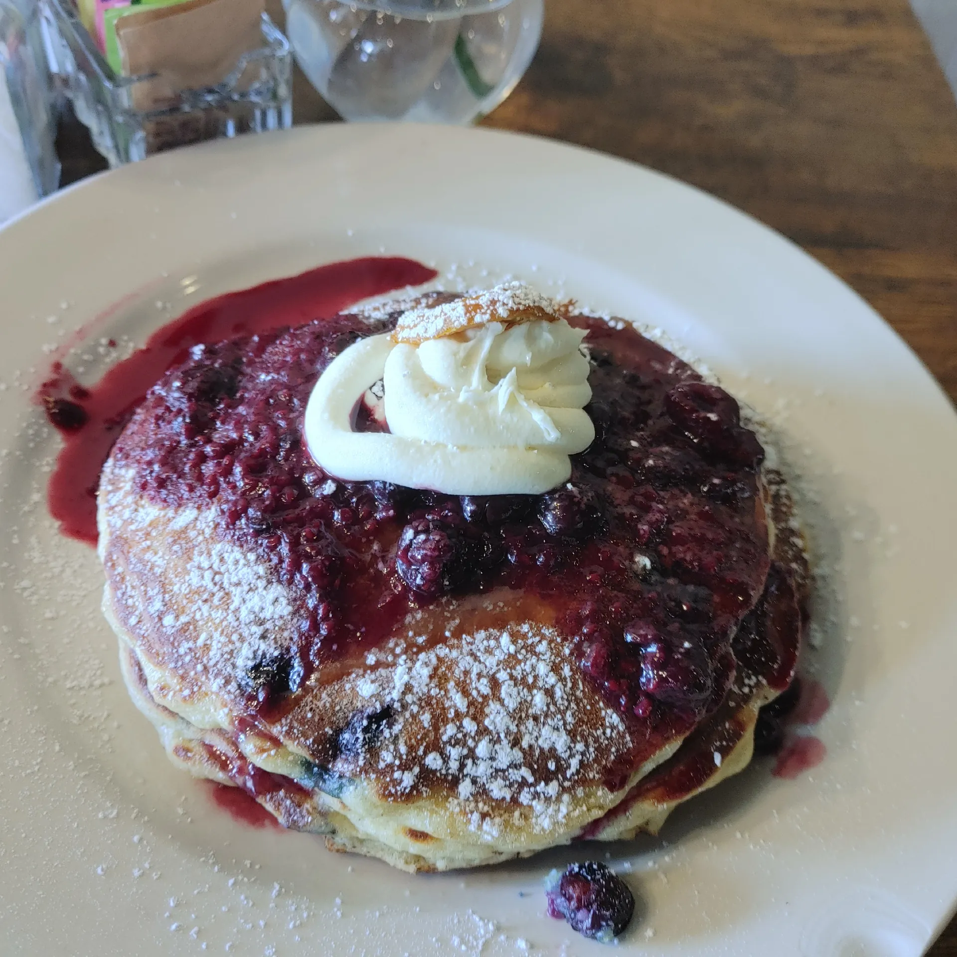 Blueberry Pancakes — a stack topped with honey butter, lemon sauce, mascarpone, and blueberry compote