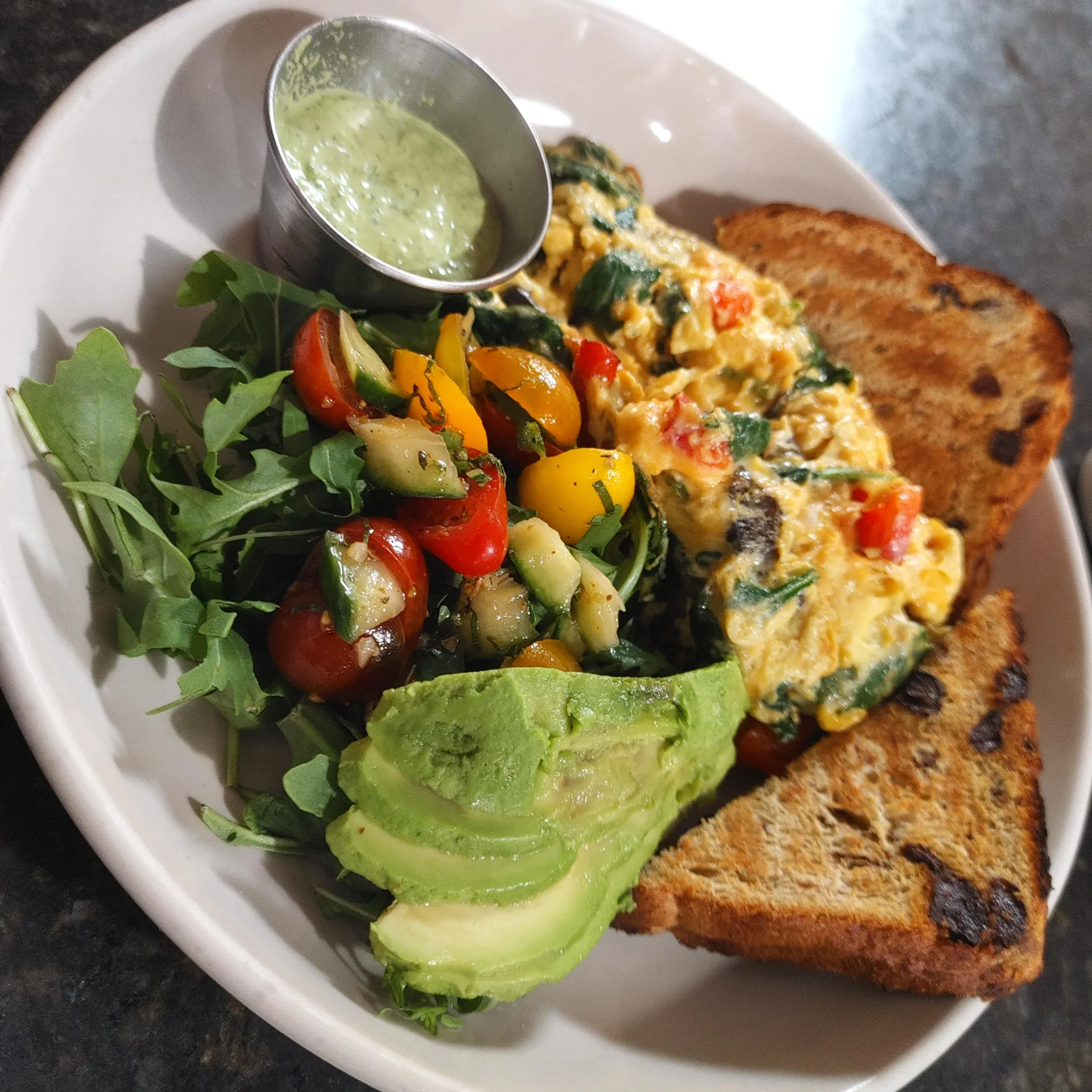 Breakfast Bowl — scrambled eggs, peppers, spinach, cheddar, avocado, and greens